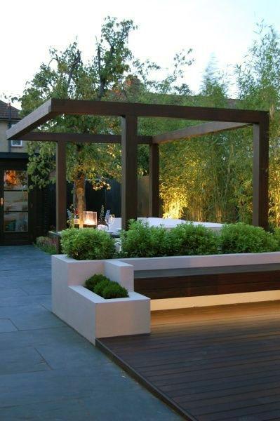 Modern pergola with minimalist design, wooden seating, built-in planters, and ambient lighting.
