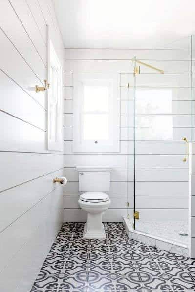 white shiplap wall bathroom with white and black tile pattern flooring