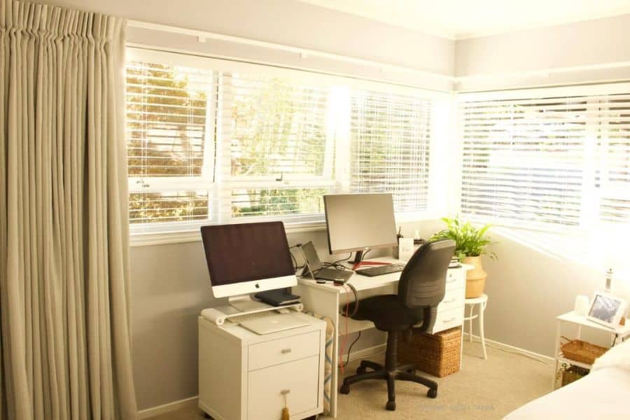 home office setup white desk and filing cabinet two screens