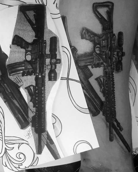 Black and grey AR-15 tattoo with a tactical scope and grip, featuring detailed shading for a realistic look, symbolizing strength and precision.