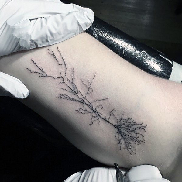 Fine line neuron tattoo on inner arm with delicate, branching dendrites and a long, slender axon for a minimalist look.