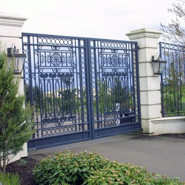 Detailed iron driveway gate with symmetrical patterns and decorative circular accents.