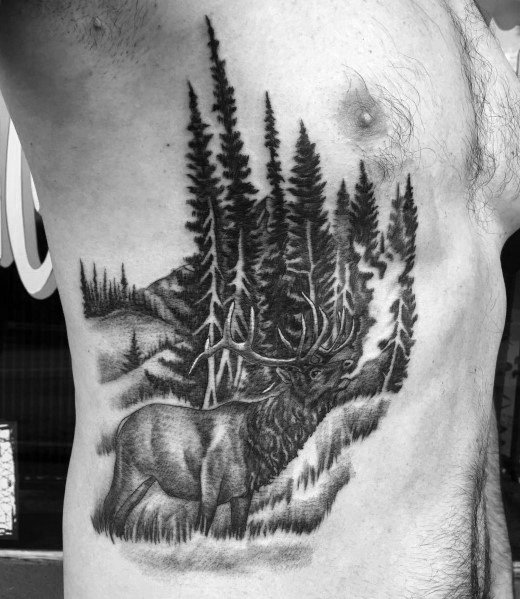 Black and grey elk tattoo on the ribcage, featuring detailed shading and a forest background for a bold and nature-inspired design.