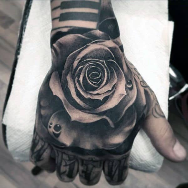 Detailed Mens Hand Tattoo Of Black Ink Rose Flower With Water Droplet