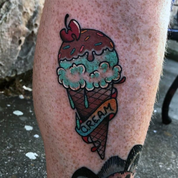 Vintage-style tattoo of an ice cream cone with mint and chocolate scoops, sprinkles, a cherry on top, and a banner reading "Cream."