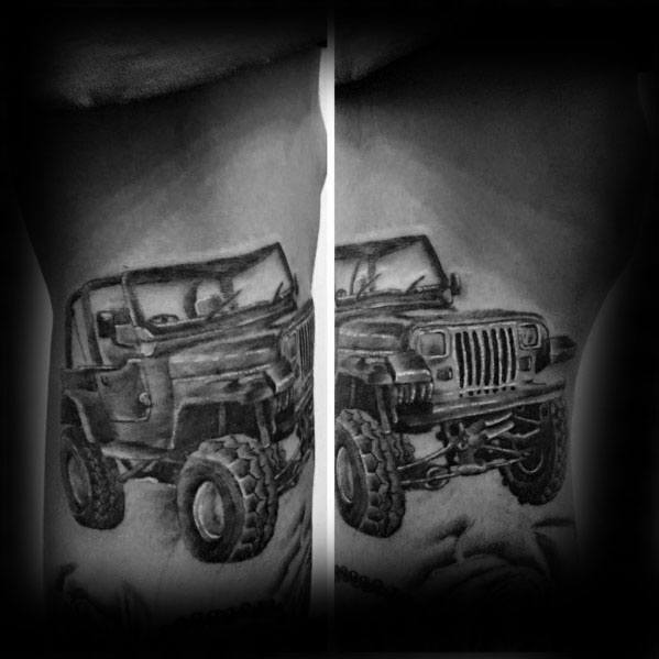 Black and grey Jeep tattoo spanning both arms, featuring a rugged off-road Jeep split between the forearms, creating a dynamic and detailed design.