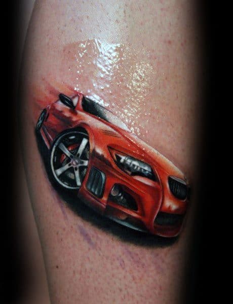 Vibrant BMW sports car tattoo on leg, featuring bold red color, dynamic motion effects, and realistic shading for a striking design.
