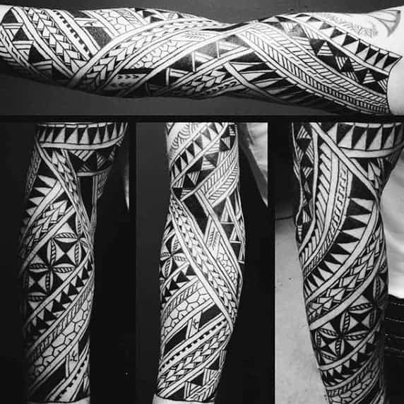 Detailed black geometric tattoo sleeves on a person's arms