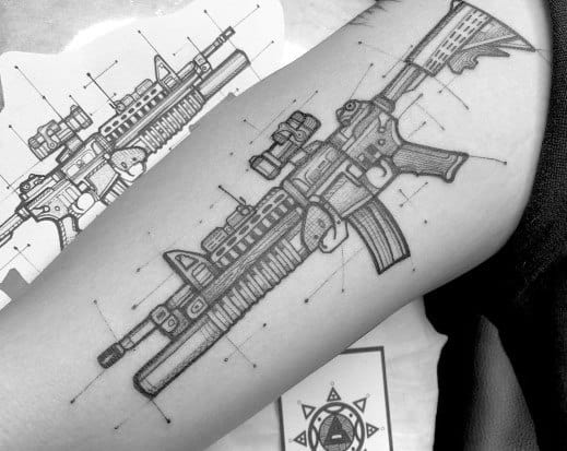 Black and grey AR-15 blueprint-style tattoo on the forearm, featuring technical linework and intricate details, symbolizing precision and firearm mechanics.