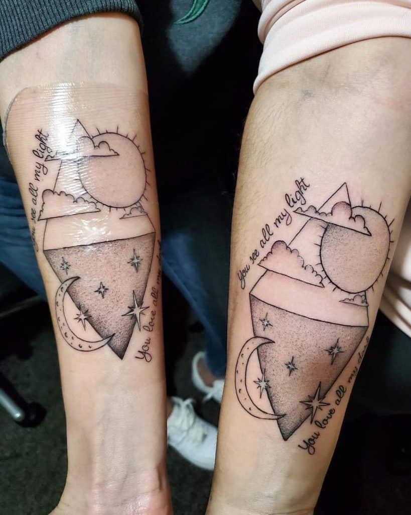 Matching forearm tattoos featuring a sun and moon inside an abstract geometric design, with the phrases "You are all my light" and "You have all."