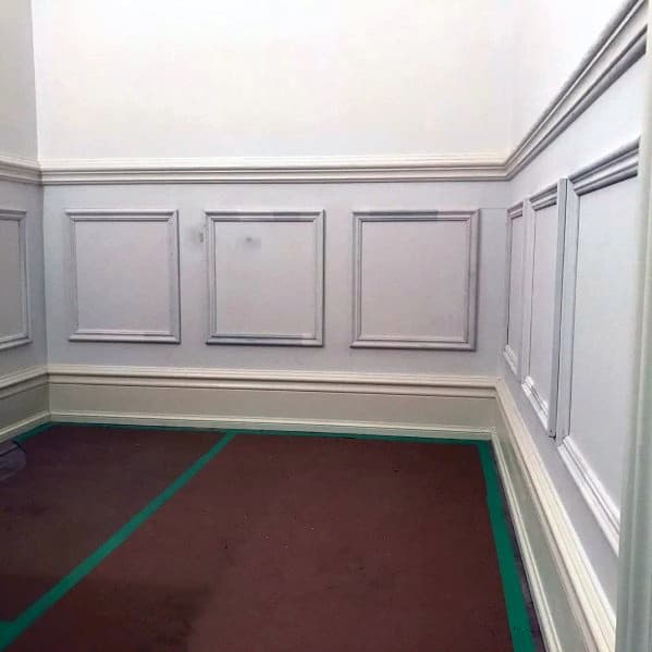 Room featuring detailed chair rail molding with symmetrical trim panels for a polished and classic design