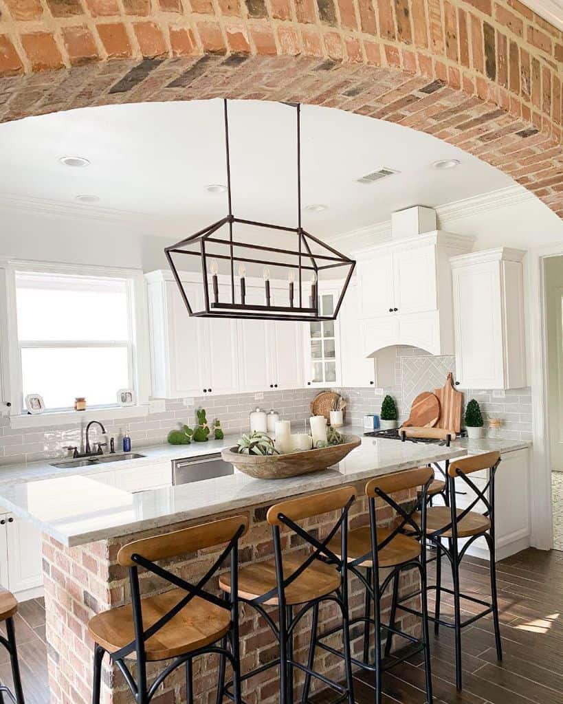 white farmhouse kitchen with brick island and seating