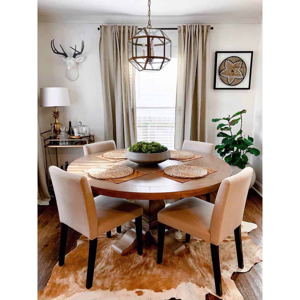 round wood dining table and brass bar cart