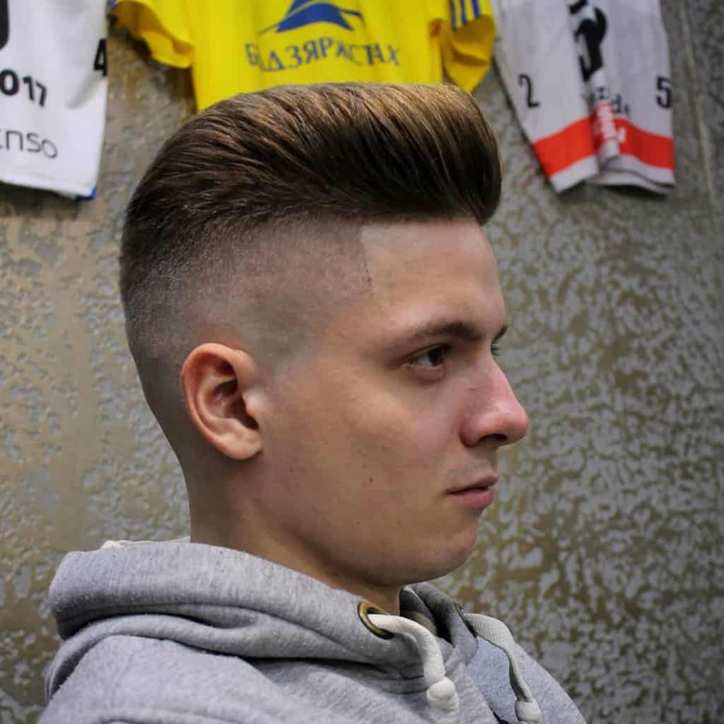 A disconnected undercut paired with clean-shaven sides and back and slightly longer hair on top
