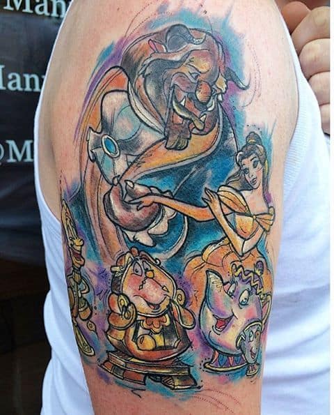 Colorful upper arm tattoo featuring Belle and the Beast dancing, with Lumière, Cogsworth, Mrs. Potts, and Chip in a lively watercolor-style design.