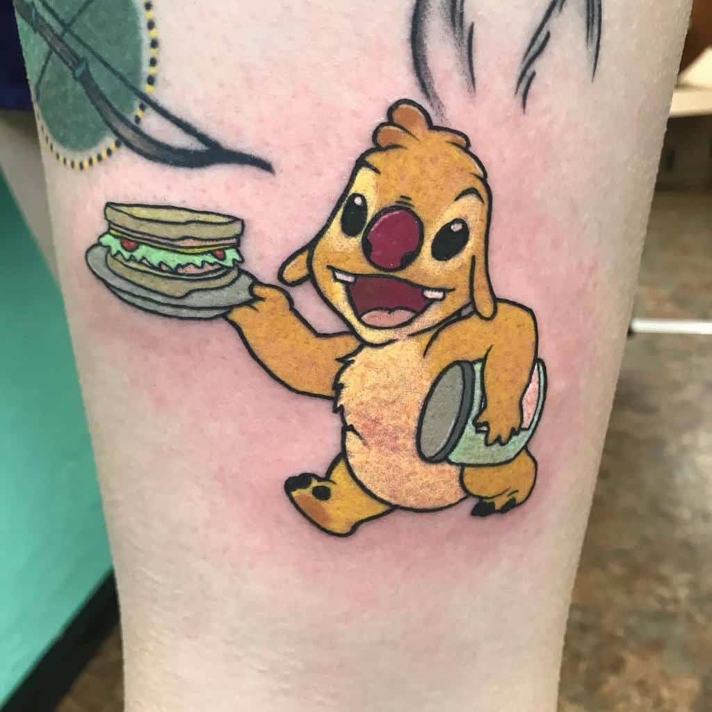 Colorful tattoo of Stitch's sister, Angel, holding a sandwich and a drum, on the thigh.