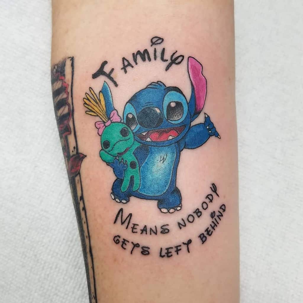 Colorful tattoo of Stitch from Lilo & Stitch holding Angel, with the text 'Family means nobody gets left behind' in a curved script, on the upper arm.