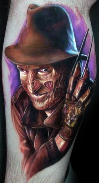 Realistic color tattoo of Freddy Krueger from *A Nightmare on Elm Street*, featuring his burned face, signature fedora, and razor glove for a chilling effect.