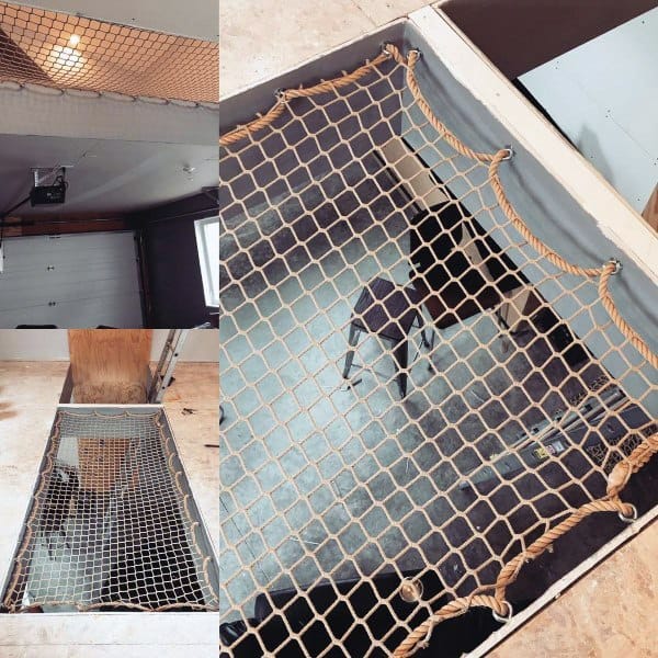 Rope net hammock installed as a floor-level feature in an industrial-style space.