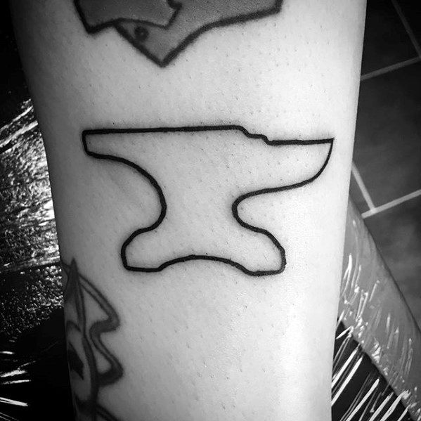 Minimalist anvil tattoo with a simple black outline on the leg, showcasing clean lines and a bold silhouette.