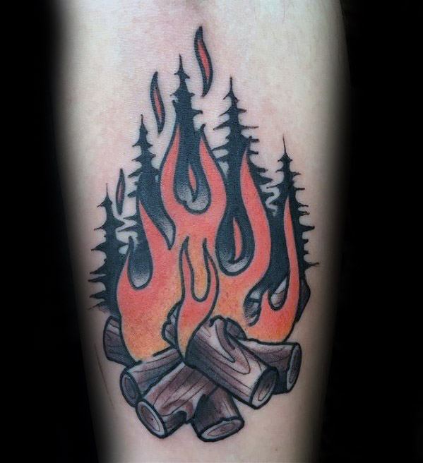 Bold campfire tattoo with glowing orange flames, stacked logs, and silhouettes of tall pine trees in the background.