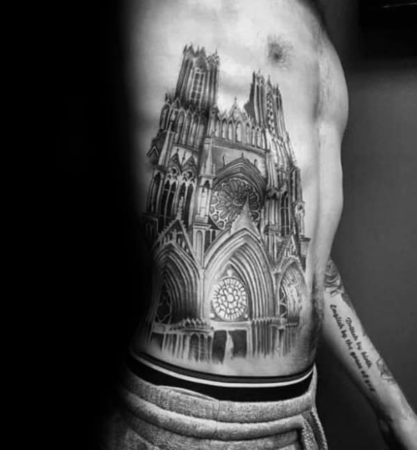 Large side torso tattoo of a gothic cathedral with detailed spires, rose windows, and realistic shading for a dramatic architectural look.