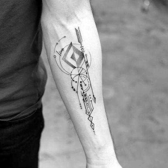 Geometric arrow tattoo on forearm featuring bold lines, circles, and abstract patterns in a modern, symmetrical design.