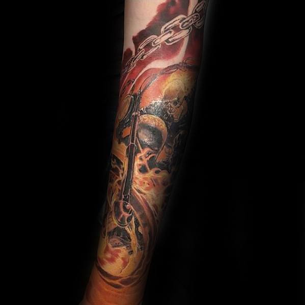 Ghost Rider sleeve tattoo with fiery skull, blazing motorcycle, swirling flames, and a bold chain wrapping around the arm.