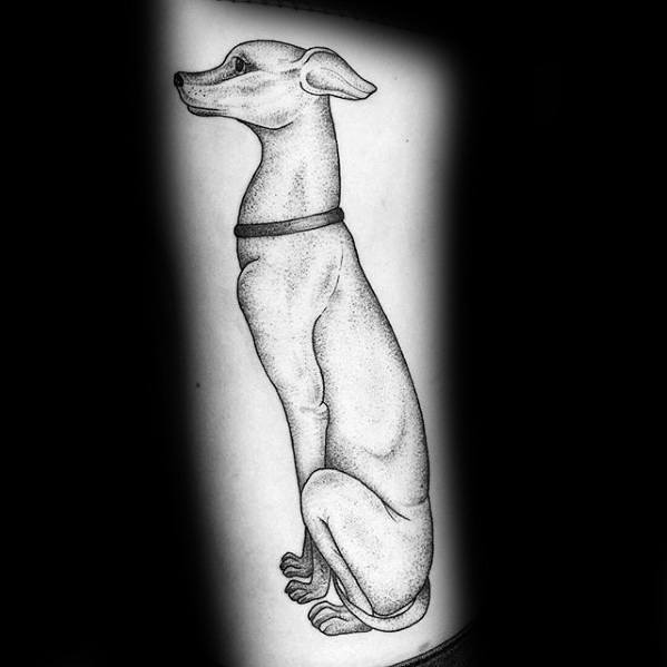 A detailed black and white tattoo of a greyhound sitting in profile, with fine dotwork shading emphasizing the dog's sleek, elegant form.