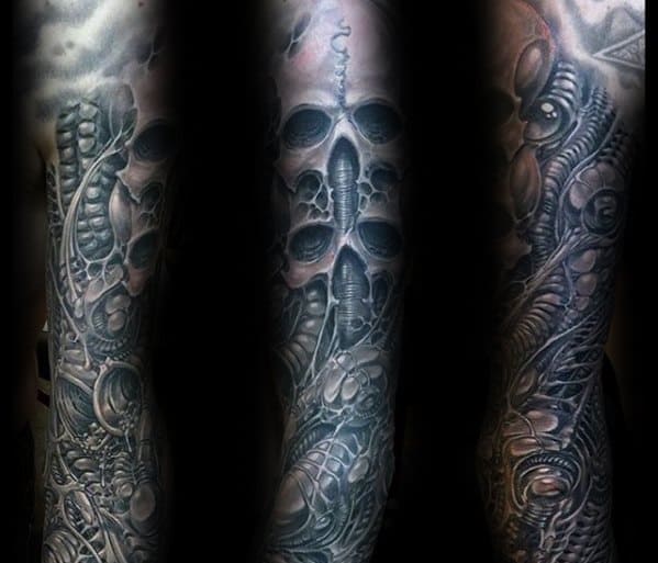 Full-sleeve HR Giger-style tattoo showcasing alien skulls, sinewy tubing, and intricate biomechanical structures with dark shading.