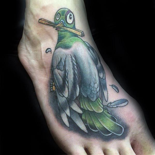 Colorful cartoon-style pigeon tattoo on foot, wide-eyed with a pencil in its beak, blending humor and creativity in a playful design.