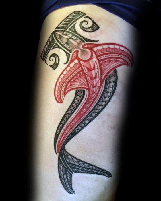 Polynesian hammerhead shark tattoo on thigh with red and black tribal patterns symbolizing courage, wisdom, and oceanic strength.