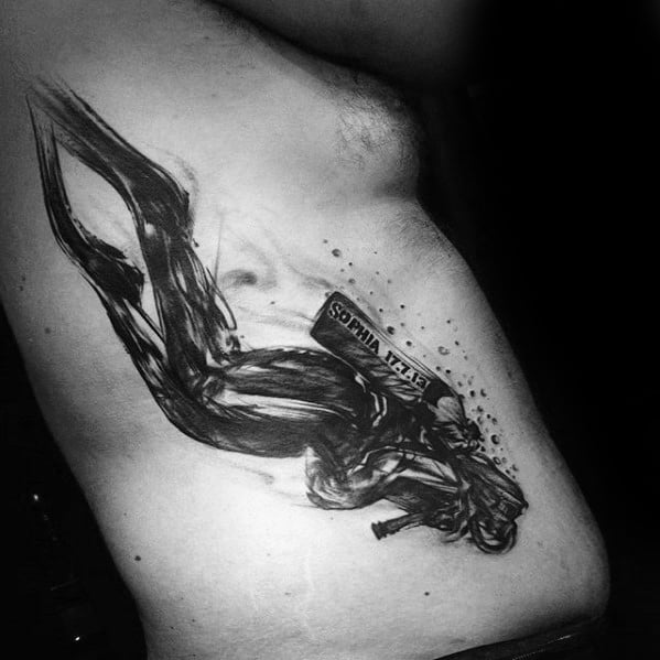 Bold black ink tattoo of a scuba diver in motion with “SOPHIA 17.7.13” written on the tank in a brushstroke style.