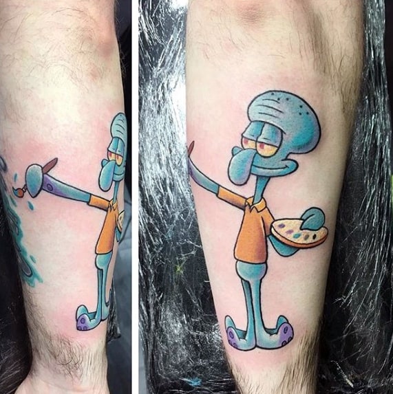 Tattoo of Squidward holding a paintbrush and palette, mid-stroke with a calm expression and artistic pose on forearm.