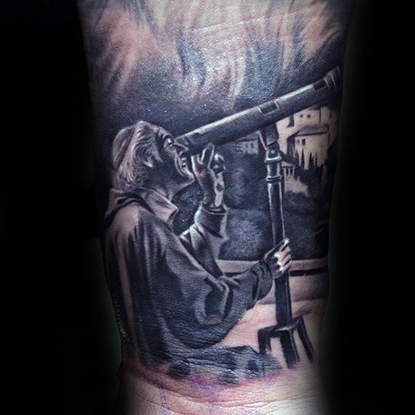 Tattoo of a man peering through a telescope beneath the vast starry sky