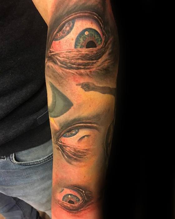 Tool-inspired sleeve tattoo with realistic, surreal eyes in varying angles and shades, creating a haunting and psychedelic effect.