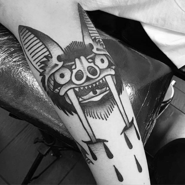 Blackwork bat tattoo with exaggerated facial features and dripping fangs, combining bold lines and a surreal traditional style.