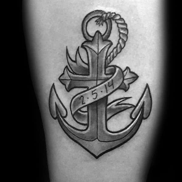 Black and grey tattoo of a cross formed into an anchor with rope detail, wrapped in a banner showing the date 2·5·14.