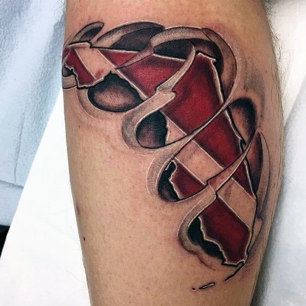 Tattoo of torn skin revealing a red and white dive flag underneath, symbolizing a deep passion for scuba diving and a lifelong connection to the ocean.