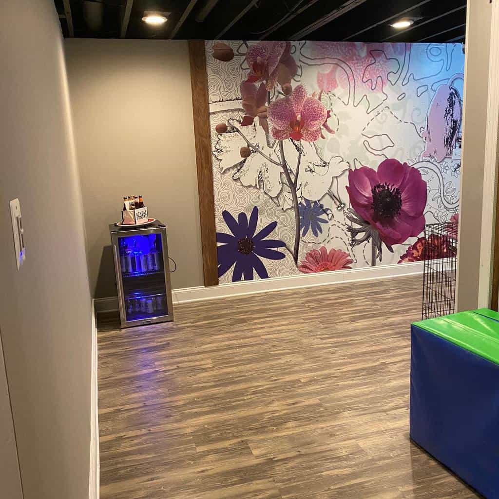 Living room with timber flooring, floral-themed wall art, and a mini beverage fridge.