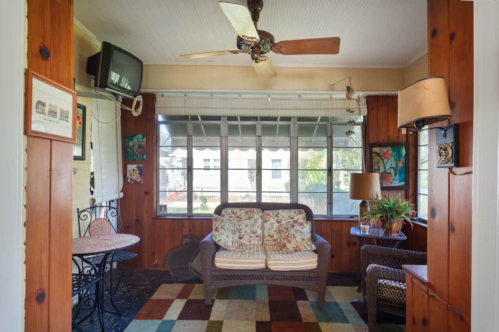 small wood enclosed patio ceiling fan wicker furniture wall mounted tv