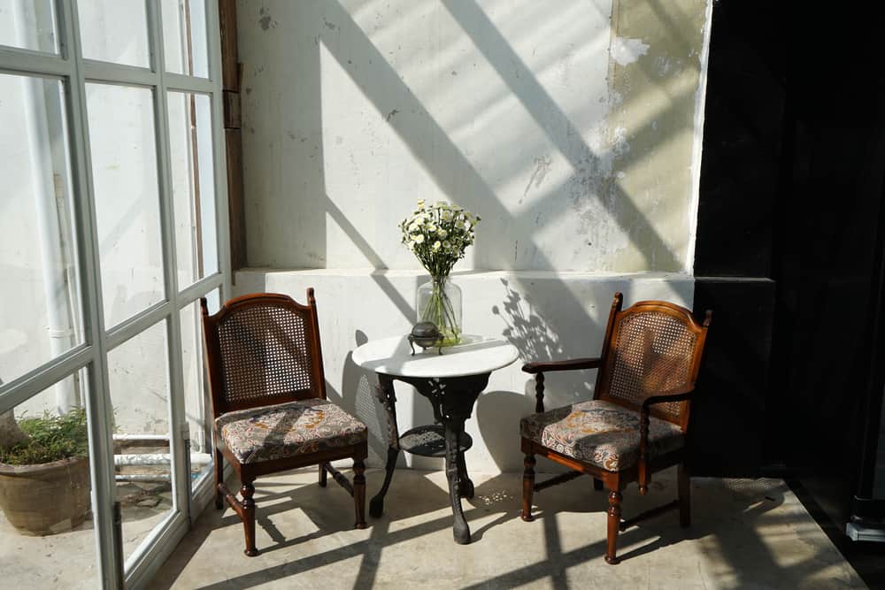 diy enclosed patio small table and chairs vase of flowers