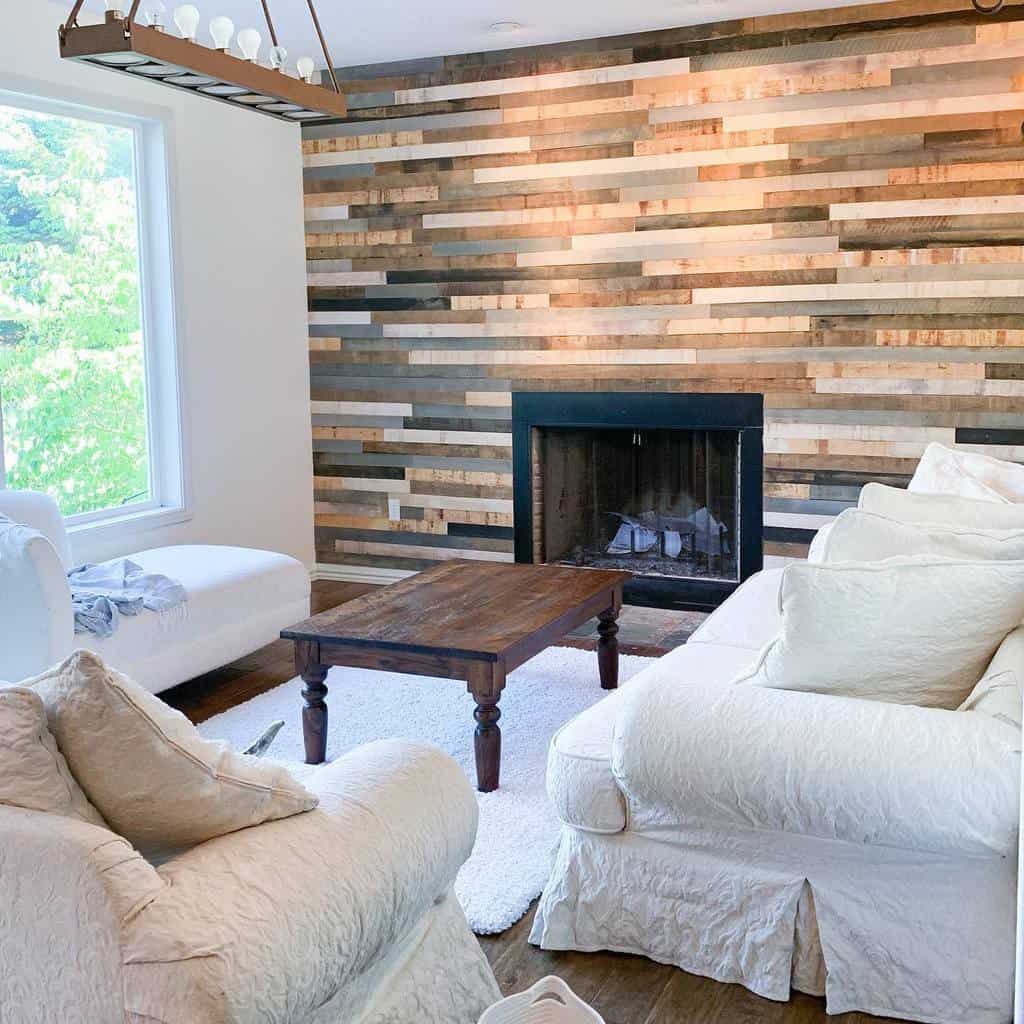 wood shiplap wall fireplace brown coffee table track lighting white sofas