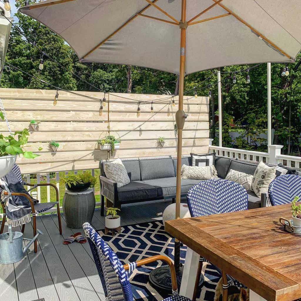 wood deck with privacy wall and umbrella shade