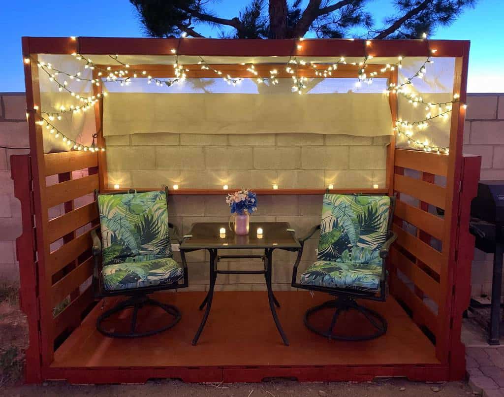 wood pallet patio with pergola and string lights 