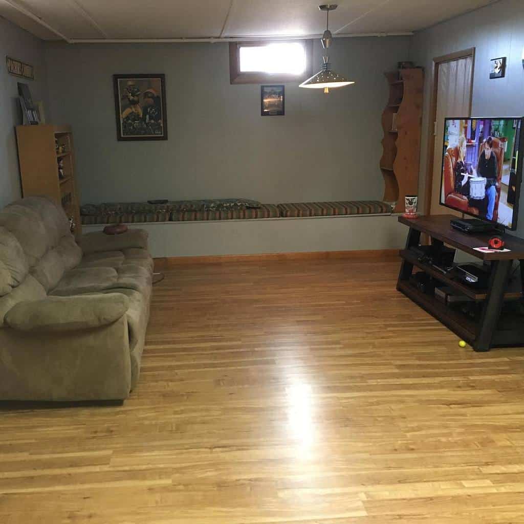 small basement living room with bench seating and sofa