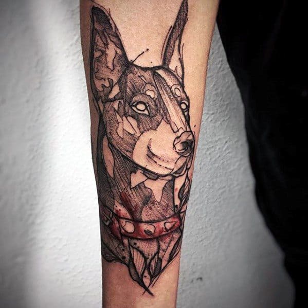 Abstract Doberman tattoo with sketch-style lines and splashes of red, creating a dynamic and artistic look on the forearm.