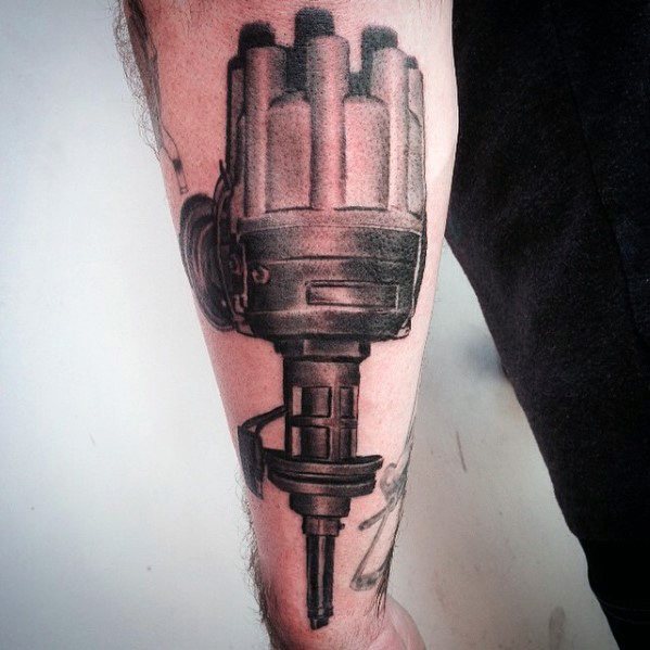 Realistic black and grey tattoo of a Dodge ignition distributor on the forearm, showcasing fine details and mechanical precision.
