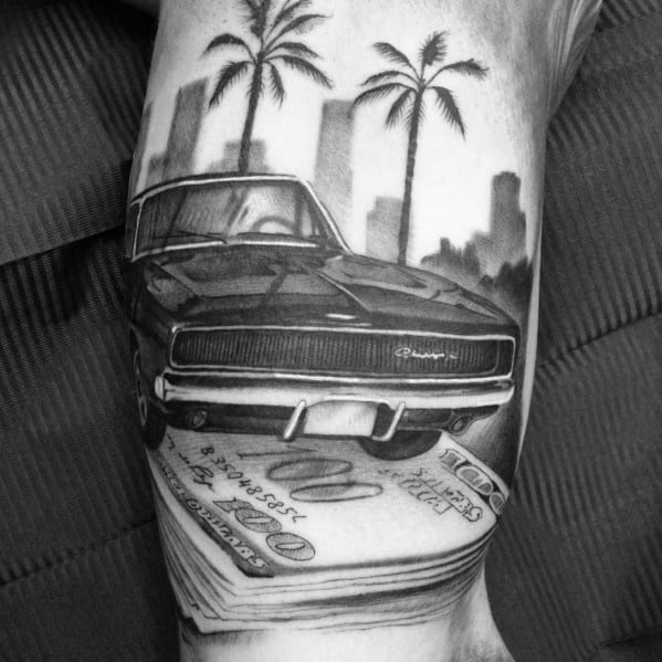 Black and grey Dodge Charger tattoo with palm trees, city skyline, and stacks of cash, symbolizing power, luxury, and success.