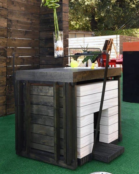 Modern dog house with a sleek wooden design, featuring a flat roof, a clean exterior, and a contemporary aesthetic, set on a green lawn